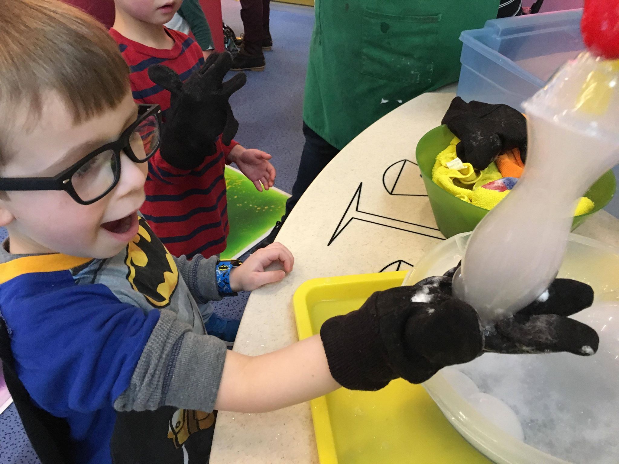 Child making an opaque ghost-shaped bubble
