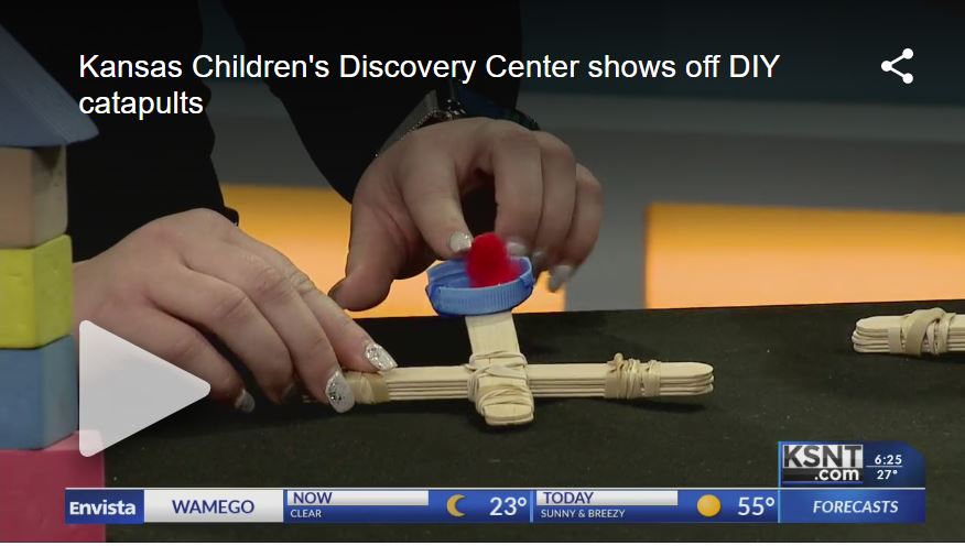 Video still from KSNT showing a close up of handmade catapults