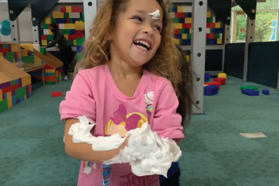 Girl playing with shaving cream